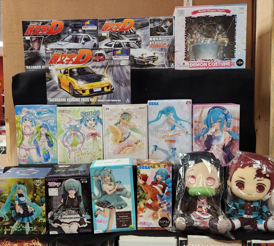 Comic collectors browsing figurines and searching for specific issues in store